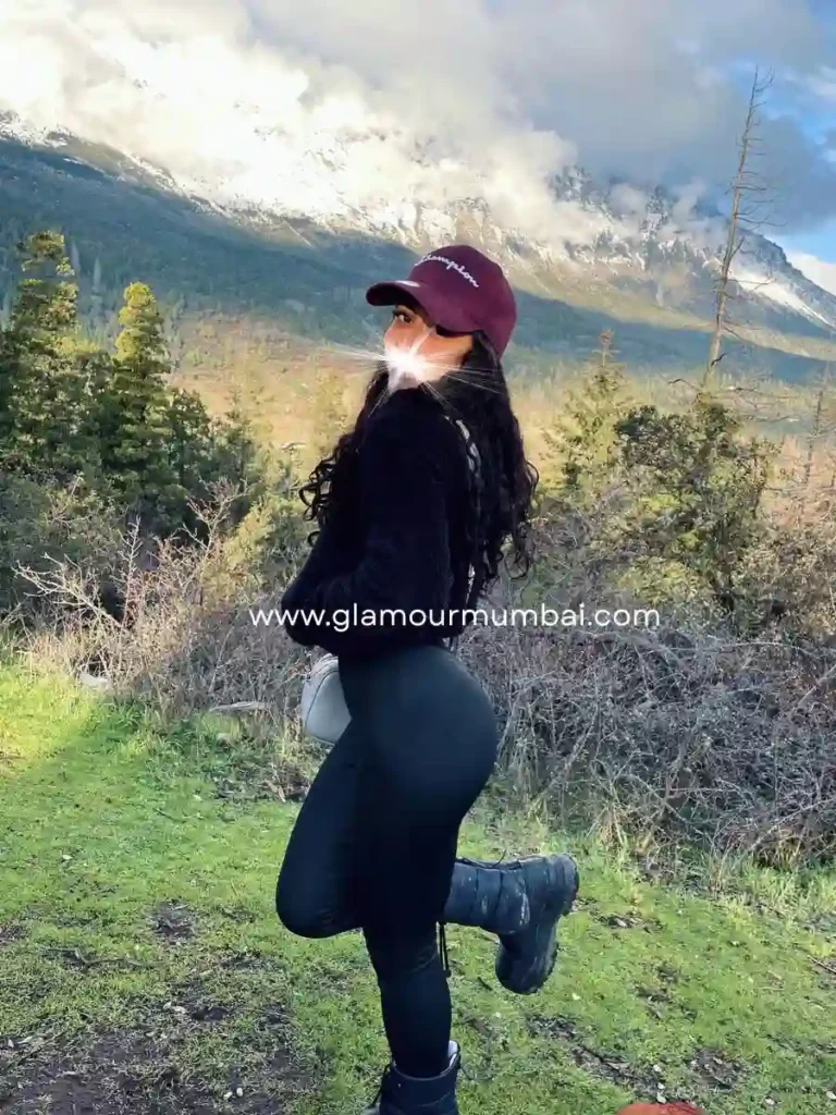 Diya in Mumbai, posing outdoors with mountain views