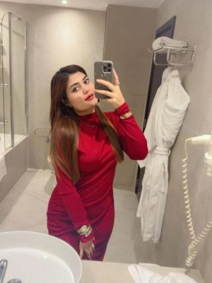 Nancy female escort in Mumbai taking a mirror selfie in a red outfit