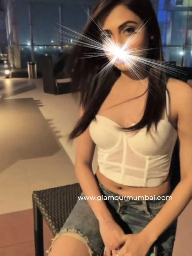 Aarohi elegant escort profile enjoying a stylish rooftop evening in a chic white top