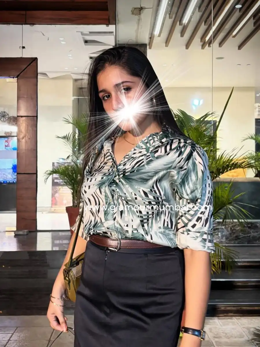 Aditi smiling warmly in a printed top and black skirt, bringing a romantic touch to Mumbai escort service.
