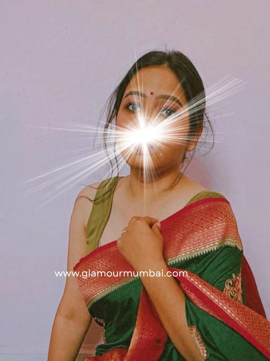 Rupali housewife escort in Mumbai wearing red and green attire, offering mature romantic companionship with comfort and healing.