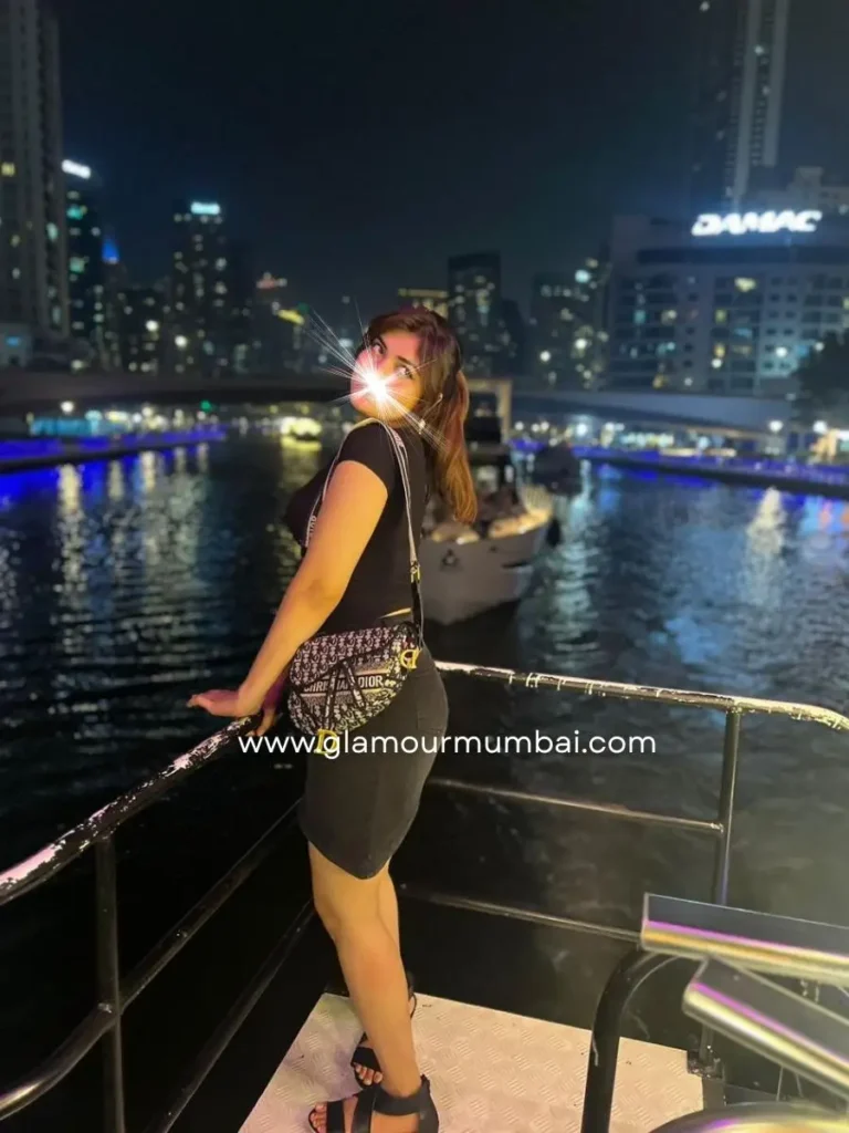 Nancy verified escort in Mumbai posing at a waterfront location during an evening outing