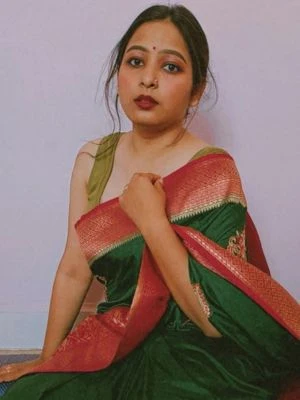 Rupali Mumbai housewife escort in red saree attire indoors.