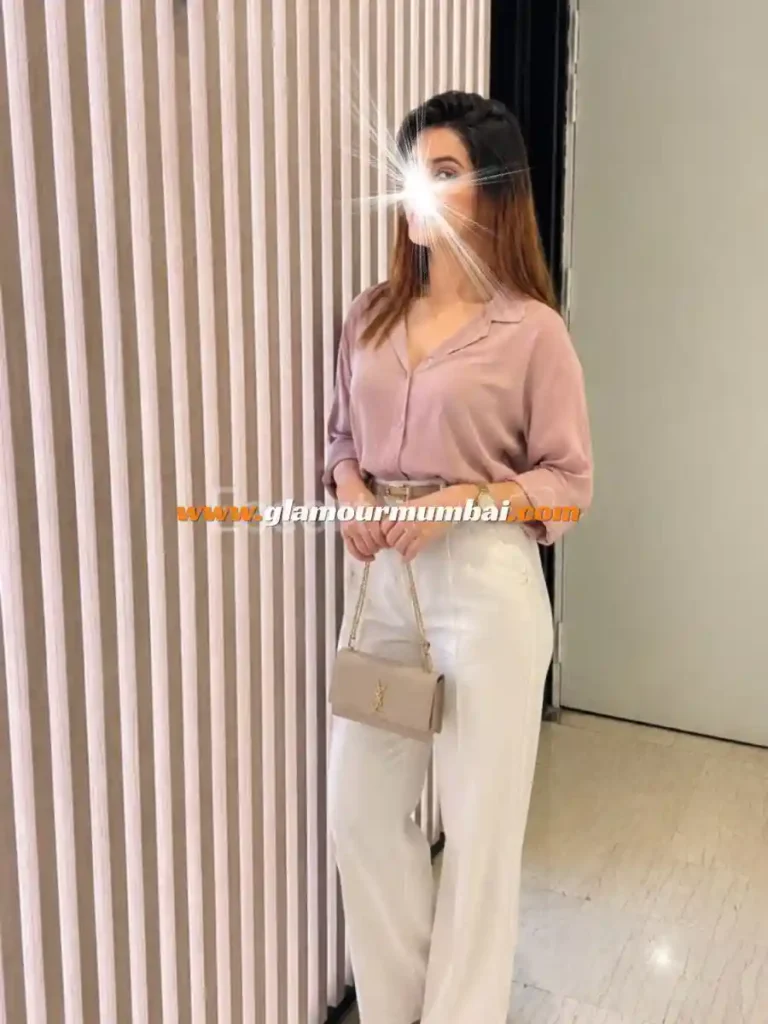 Sophia in a pink top and white pants in Mumbai